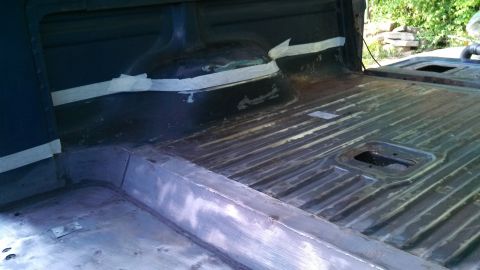 1979 Ford Bronco - The interior cargo area of a vehicle shows ribbed flooring and taped seams, suggesting ongoing work.