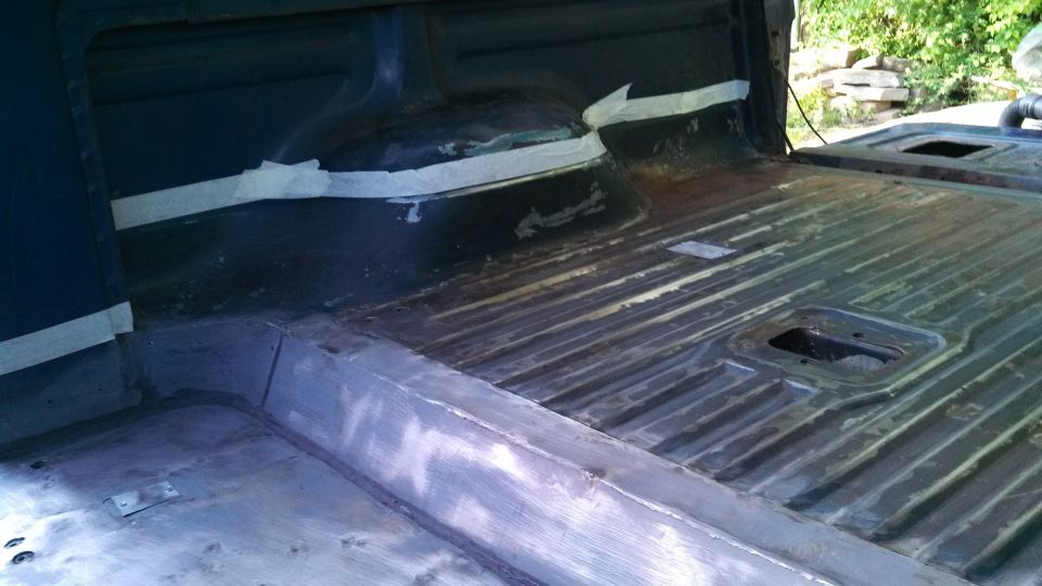 Interior cargo area of a vehicle with ribbed flooring and taped seams