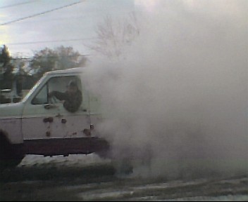 1980 Ford Bronco - A 1980 Ford Bronco is seen from the side, engulfed in a massive cloud of smoke.