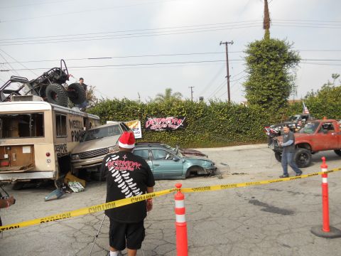 1986 Ford Bronco - A scene of destruction with multiple vehicles involved, including a monster truck atop a bus.