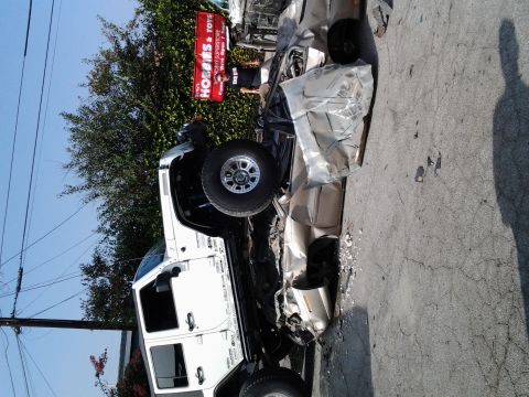 1986 Ford Bronco - Two vehicles involved in a serious collision, with one overturned and the other crushed.