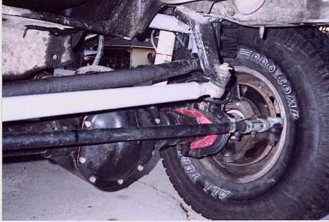1992 Ford Bronco - Close-up of the front axle and suspension on a 1992 Ford Bronco, showing Pro Comp tires.