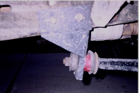 1992 Ford Bronco - Close-up view of a vehicle's suspension system, showing a bracket and shock absorber component.
