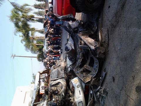 1986 Ford Bronco - A scene of multiple wrecked vehicles, with onlookers gathered to observe the aftermath.