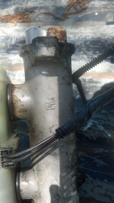 1983 Ford F-250 - Close-up of a brake master cylinder, showing a '15/16' marking, likely for a Ford F-250.