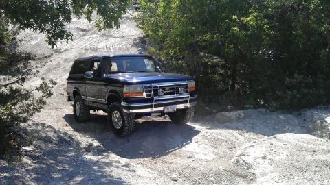 1995 Ford Bronco - This 1995 Ford Bronco is navigating a rough, off-road path.