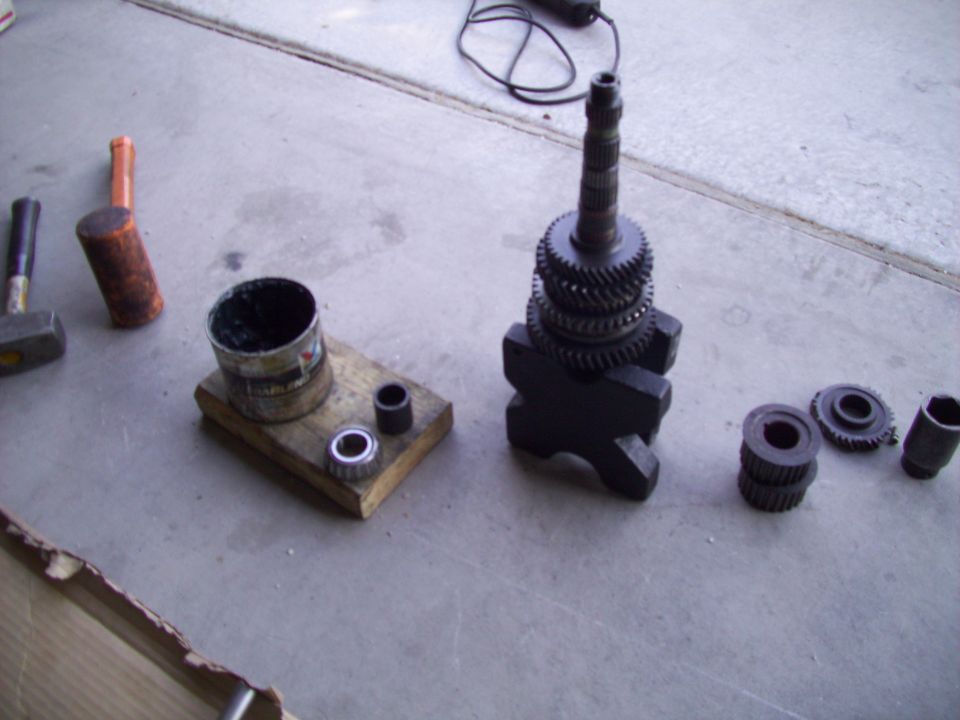Gears and tools laid out on a concrete surface