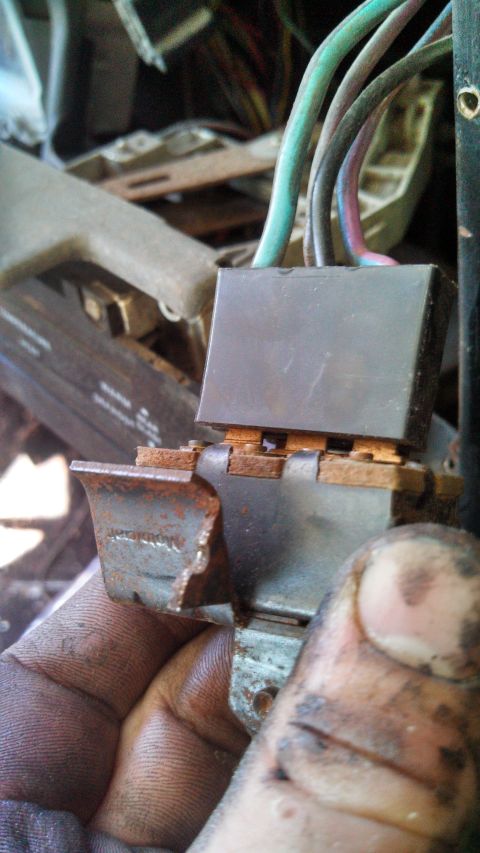 1979 Ford Bronco - A close-up view of a corroded electrical connector, likely from a vehicle's interior wiring system.