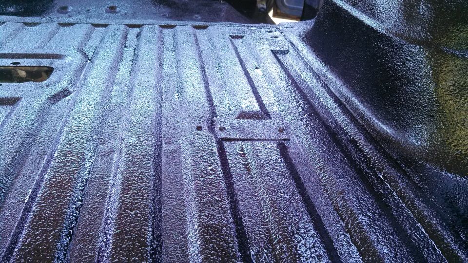 close-up of a dark, textured truck bed liner with ribbed floor