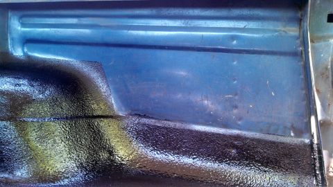 1979 Ford Bronco - Interior view of a vehicle's cargo area, showing blue paint and black undercoating.