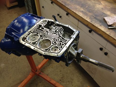 1988 Ford Bronco - The internal components of an automatic transmission are exposed after its pan has been removed.