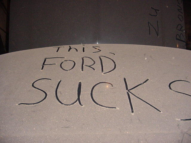 1992 Ford Bronco hood with "THIS FORD SUCKS" and "ZU BRONCO" scratched into it