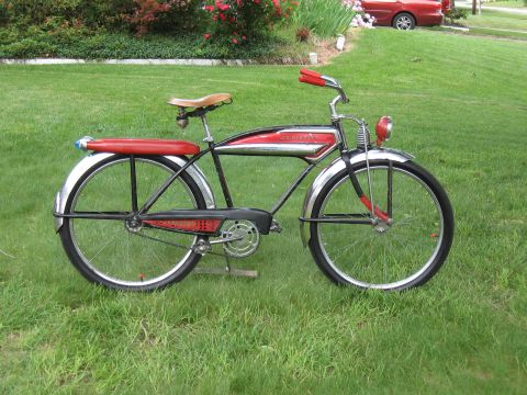 1994 Ford Bronco - A vintage bicycle with a red seat and handlebars sits on a green lawn.