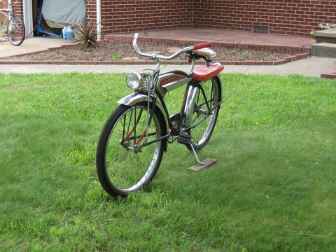 1994 Ford Bronco - A vintage bicycle with chrome fenders and red accents sits on a lawn, with a garage in the background.
