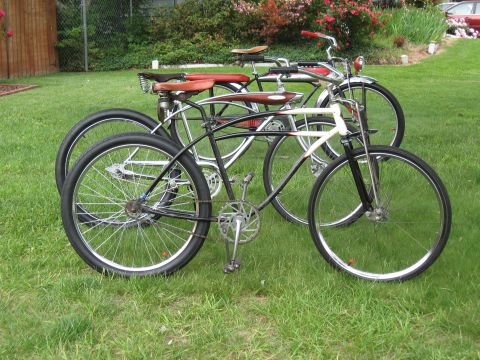 1994 Ford Bronco - Two bicycles are parked on a grassy lawn with a wooden fence and bushes in the background.