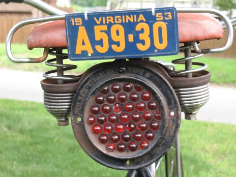 1994 Ford Bronco - Vintage bicycle tail light and 1953 Virginia license plate are shown up close.