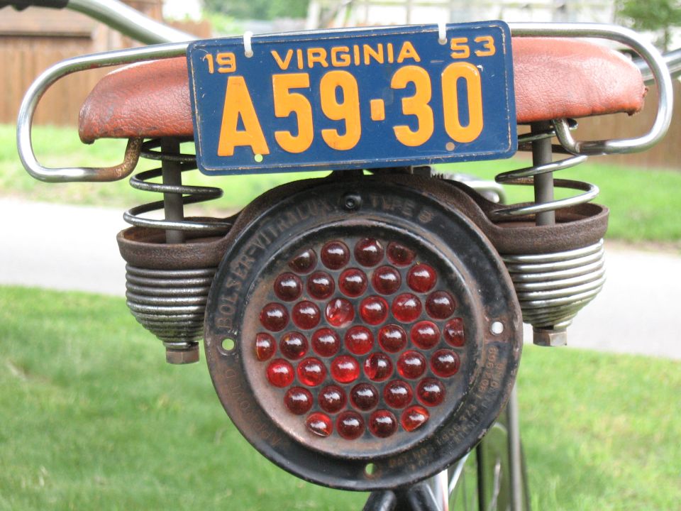 1953 Virginia license plate A59-30 mounted above a round red bicycle tail light