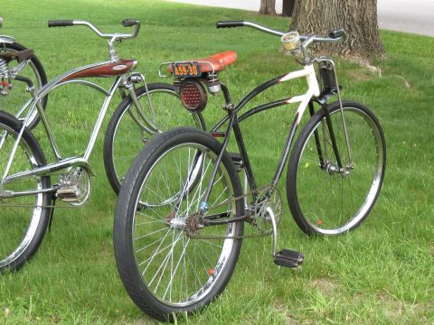 1994 Ford Bronco - A pair of classic bicycles are displayed outdoors on a grassy lawn.