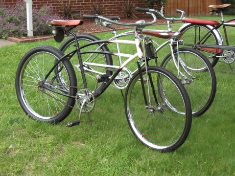1994 Ford Bronco - Several vintage bicycles are parked on a grassy lawn in front of a brick building.