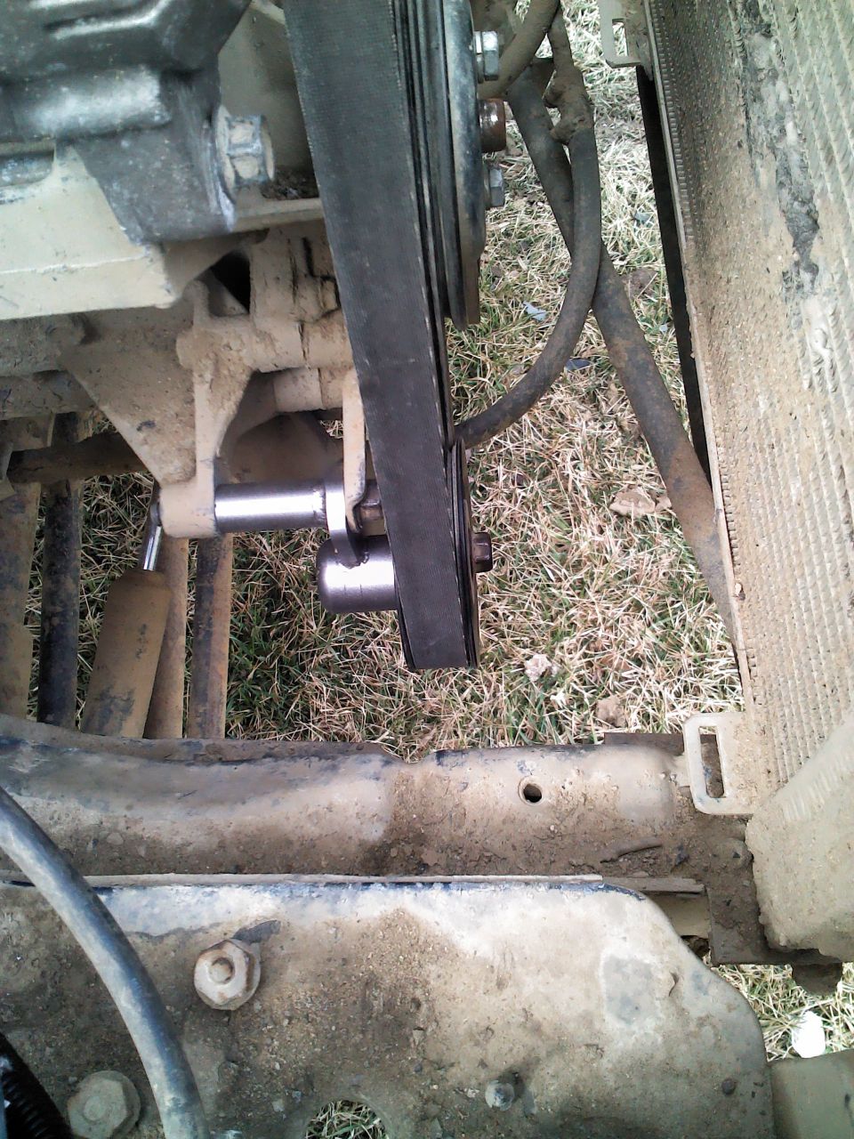 Engine belt and pulley system with SuperMotors logo visible