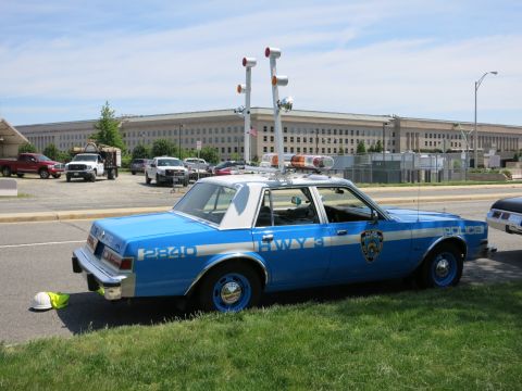 1991 Ford LTD Crown Victoria - blue-and-white NYPD Highway police sedan with roof light bar and floodlights parked near the Pentagon.