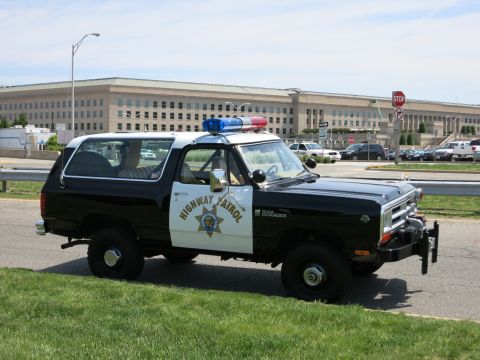1991 Ford LTD Crown Victoria - black-and-white Dodge Highway Patrol SUV with roof light bar and winch parked near the Pentagon.