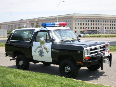 1991 Ford LTD Crown Victoria - Front view of a black-and-white Dodge Ram Charger Highway Patrol SUV with light bar parked near the Pentagon.