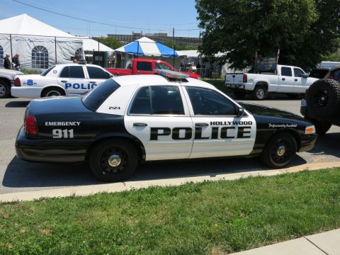 1991 Ford LTD Crown Victoria - black-and-white Hollywood Police Ford Crown Victoria patrol car lettered EMERGENCY 911 parked near tents.