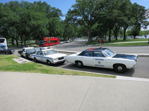 1991 Ford LTD Crown Victoria - white 'New York State Police' sedan sits angled in a parking area beside a black-and-white police car.