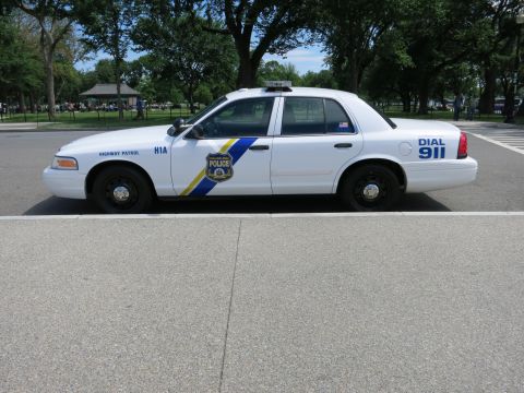 1991 Ford LTD Crown Victoria - white Philadelphia Police Highway Patrol Crown Victoria viewed in side profile on pavement, with a blue and yellow stripe and DIAL 911 mark…