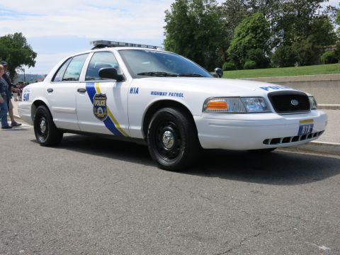 1991 Ford LTD Crown Victoria - Front three-quarter passenger-side view of a white Philadelphia Police Highway Patrol Crown Victoria marked H1A on a sunny street.