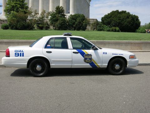 1991 Ford LTD Crown Victoria - white Philadelphia Police Highway Patrol Crown Victoria parked in side profile in front of a columned marble monument, marked DIAL 911.