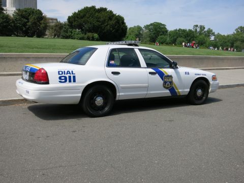 1991 Ford LTD Crown Victoria - Rear three-quarter view of a white Philadelphia Police Highway Patrol Crown Victoria marked DIAL 911 and H1A, parked on a paved lot.