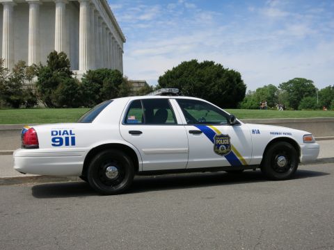 1991 Ford LTD Crown Victoria - white Philadelphia Police Highway Patrol Crown Victoria parked in profile in front of a columned memorial under a blue sky, marked DIAL 911…