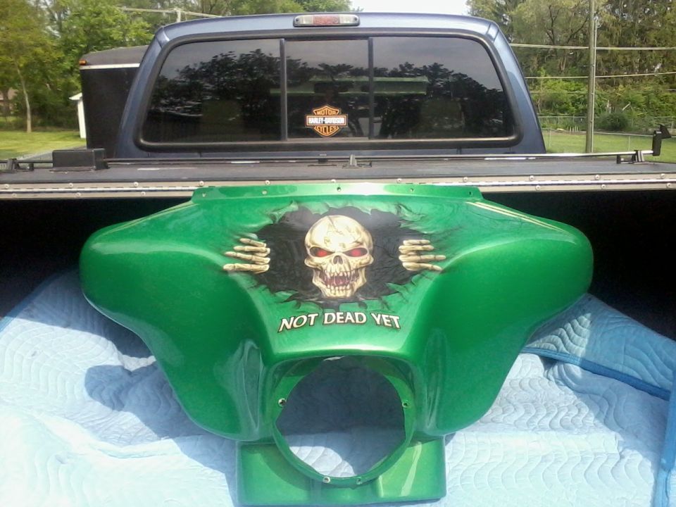 Green motorcycle fairing with skull graphic and 'NOT DEAD YET' text