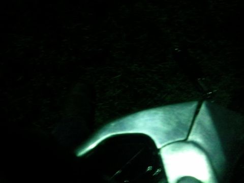 1995 Ford F-150 - Illuminated headlight and fender section of an unknown vehicle.