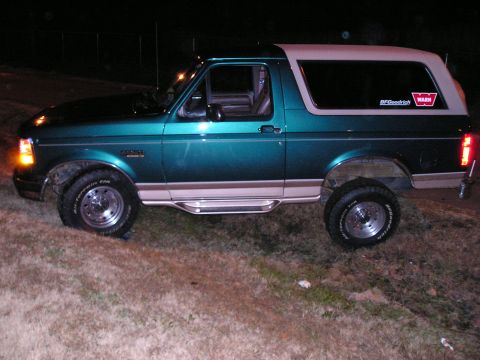1996 Ford Bronco - This 1996 Ford Bronco is shown in a side profile, its distinctive two-tone paint scheme and off-road tires.