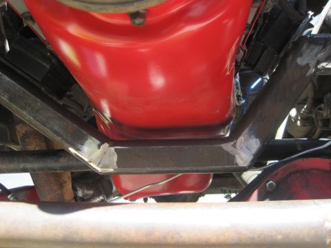 1989 Ford Bronco - Underside view of an engine oil pan and its supporting crossmember.