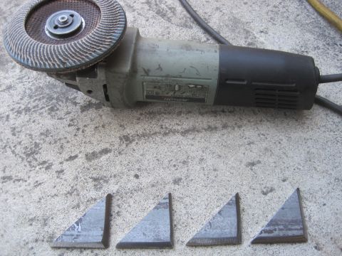 1989 Ford Bronco - Angle grinder and metal pieces prepared for cutting or grinding.