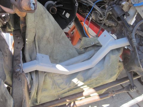 1989 Ford Bronco - Close-up view of a vehicle's engine bay, highlighting a freshly painted cross member and surrounding suspension parts.