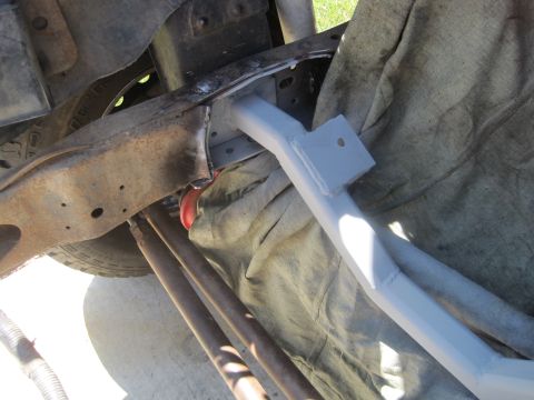 1989 Ford Bronco - Vehicle frame and suspension parts are visible, with a newly painted cross member.