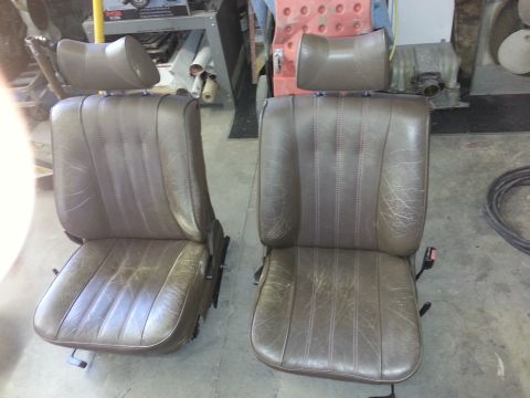 1967 Ford F-100 - Two brown leather bucket seats with adjustable headrests are shown, likely for a vehicle interior.