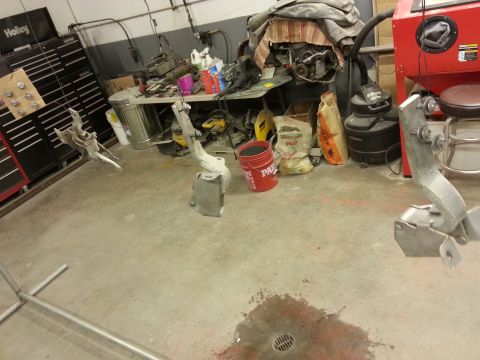 1967 Ford F-100 - Various vehicle parts are shown in a workshop setting, with tools and supplies in the background.