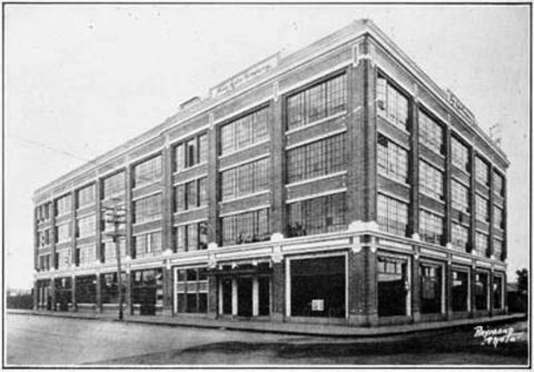 1909 Ford Model T - This is a photograph of a large brick building, likely a factory or commercial establishment.