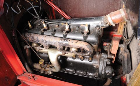 1909 Ford Model T - This image shows the engine compartment of a vintage automobile, focusing on the engine block and its components.