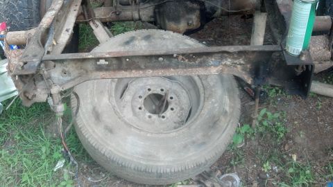 1983 Ford F-250 - This image shows a part of a truck frame and a spare tire, not a complete vehicle.