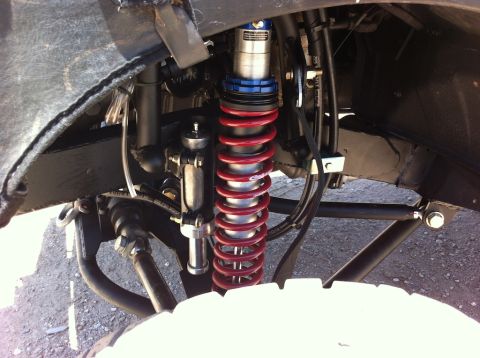 1987 Suzuki Samurai - Custom suspension components, including a red coilover shock, are visible on the front axle.