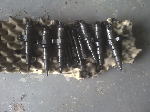 2005 Dodge 3500 - Multiple fuel injectors are laid out on a cloth, ready for installation or sale.