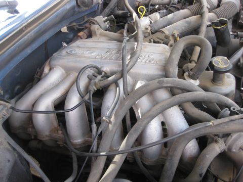 1988 Ford Bronco - Close-up of a Ford engine's intake manifold, showing "Electronic Fuel Injection" text.