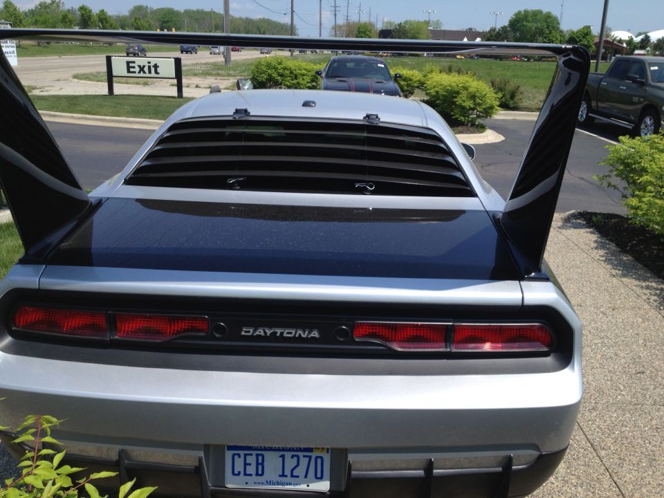 Silver car with large rear wing and louvers, 'DAYTONA' badge visible